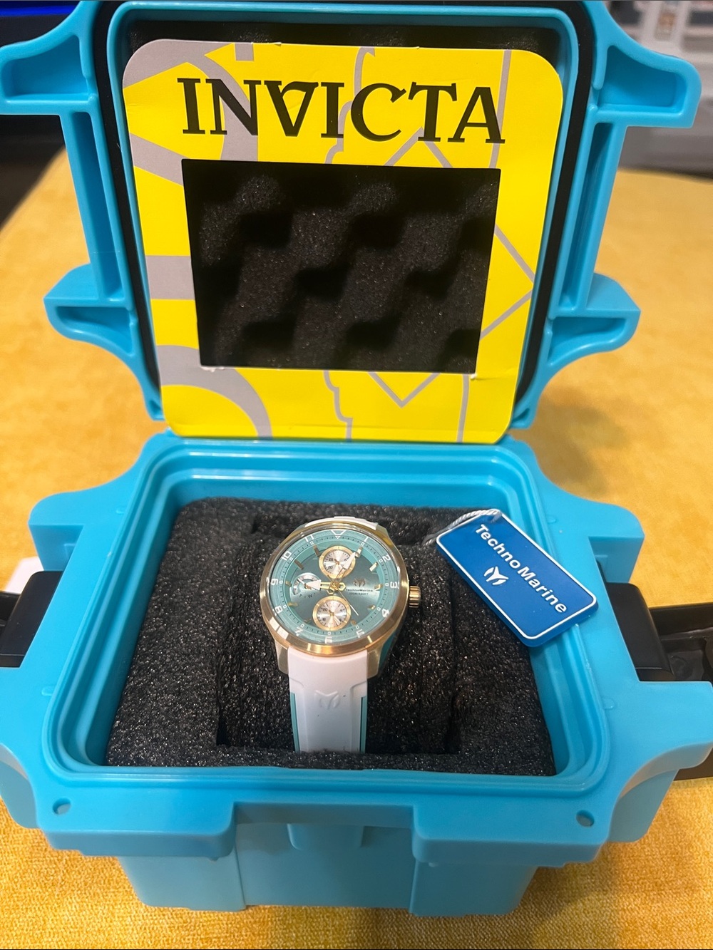 Invicta Teal Dial Watch with White Strap and Gold Accents